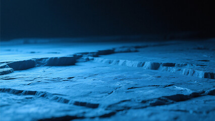 A blue toned landscape with cracked terrain and a dark horizon under a dim and muted light