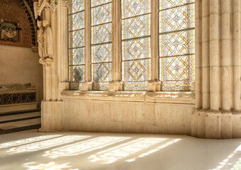 Gothic arches and colorful stained glass in Burgos Cathedral.