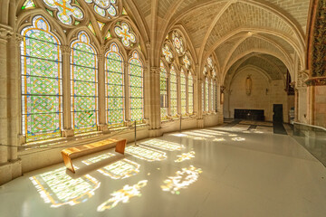 Gothic arches and colorful stained glass in Burgos Cathedral.
