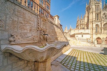 Ancient fountain and the magnificent Burgos Cathedral in Spain.
