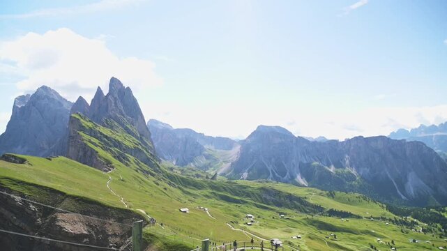 Panoramic view of Seceda ridgeline and vast alpine valley in Dolomites under a bright sky Wide-angle shot of Seceda ridgeline in the Italian Dolomites with clear blue sky and expansive alpine valley