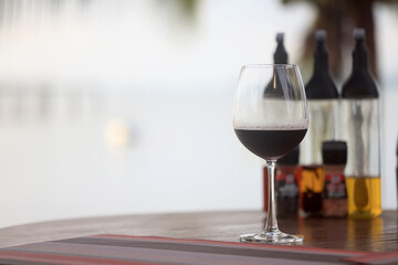 dinner in a restaurant with wine, beautiful table setting, a glass of wine in the foreground
