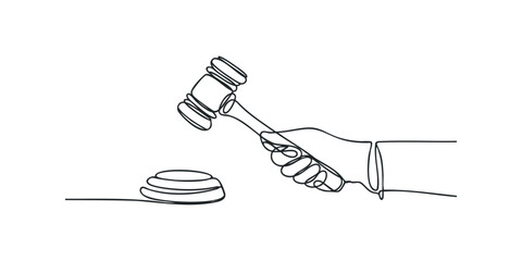 Hand holding judge's gavel striking sound block
