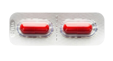Isolated capsule blister pack, close-up for healthcare concept, with two red pills inside