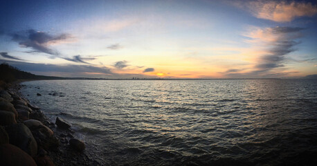 Coastal sunset panorama with dramatic skies and reflective waters near Pirita, Tallinn, Harjumaa, Estonia, November 2017