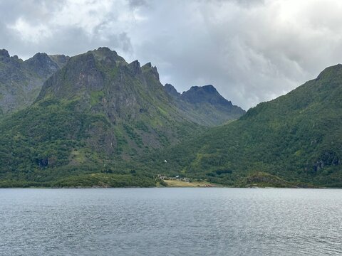 Scenic view of the mountains and water of the Sloverfjorden under cloudy sky, Fiskeb&oslash;l, Hadsel, Nordland, Norway, August 2024