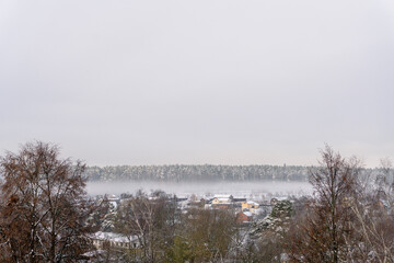 White fog spreads across the valley and covers the village
