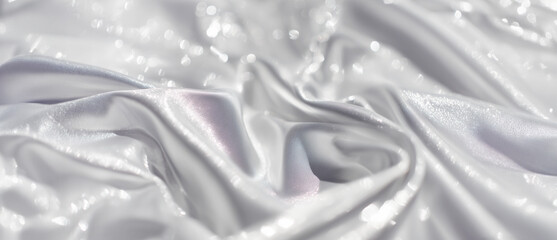 Elegant background of silver silk, fluid drapery with glowing highlights, rich texture and subtle depth, luxury fashion advertising feel