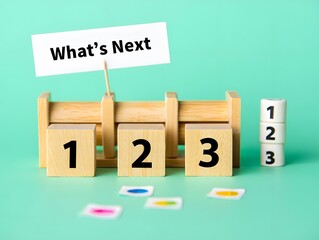 What's next?, business concept. Next step of work, plan, strategies, vision, project implementation, new opportunities and execution. Putting wooden cubes with What's next? 