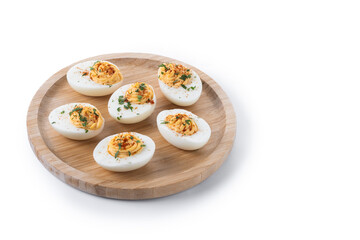 Homemade hard Boiled Deviled Eggs garnished with herbs isolated on white background. Copy space
