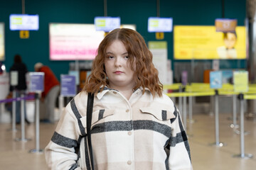 Young woman at registration area in airport. Modern passenger scene