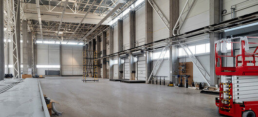 Spacious industrial warehouse interior with high ceilings and concrete floors.