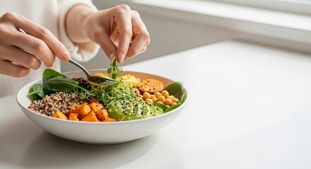 Close-up of hands enjoying a fresh and nutritious plant-based buddha bowl.