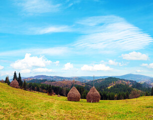 Breathtaking landscape with a haystack in the autumn mountains of the Carpathians.