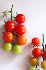 Fresh cherry tomatoes on a clean white background. Ripe organic vegetables with copy space, ideal for food design, healthy lifestyle, farm market, or natural product packaging.