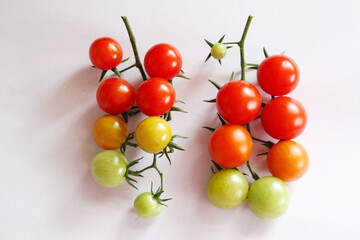 Fresh cherry tomatoes on a clean white background. Ripe organic vegetables with copy space, ideal for food design, healthy lifestyle, farm market, or natural product packaging.