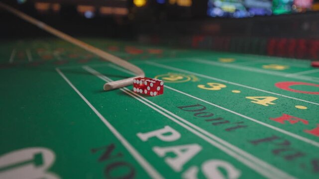 A close-up shot of Santa Claus reaching for red craps dice rolling across a green casino table.