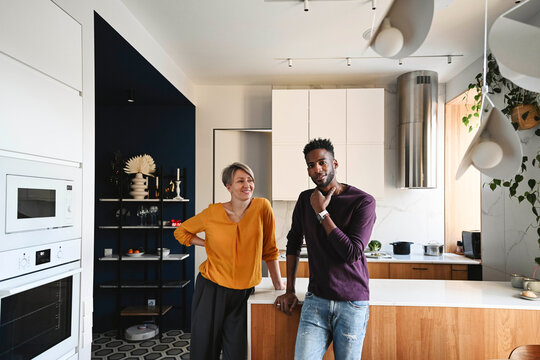 Couple enjoying a relaxed morning together in a modern kitchen
