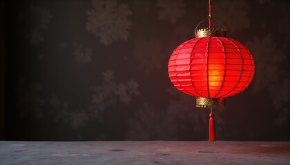 Red paper lantern with golden accents hanging on textured dark background for Lunar New Year