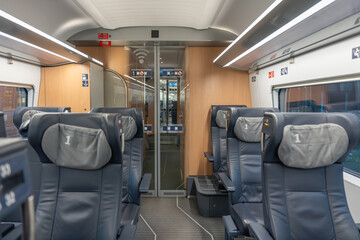 A first-class train compartment with wide leather seats and large windows. The modern design...
