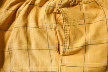 close up of side pocket of gingham pattern pants