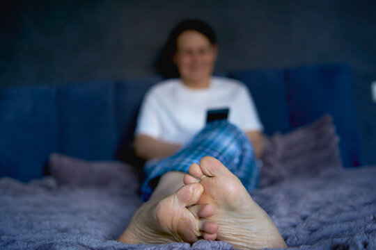 a senior woman chatting on the phone in bed