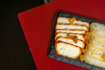 Traditional Portuguese cheese board from Alentejo, featuring local cured cheeses served on a rustic schist stone slab, showcasing authentic regional flavors and artisanal presentation.