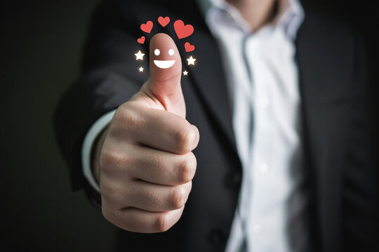 Thumbs up with smile and heart icons for positive feedback and approval concept stock photo and image