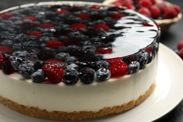 Delicious cheesecake with berries on black table, closeup