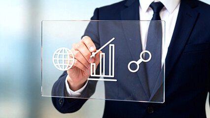 Businessman interacting with digital business icons