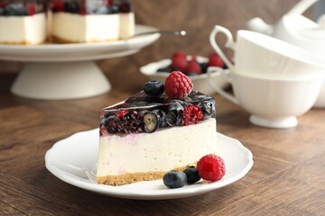 Piece of delicious cheesecake with berries on wooden table, closeup