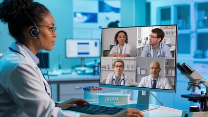 Doctor consulting with colleagues via video conference in a laboratory setting