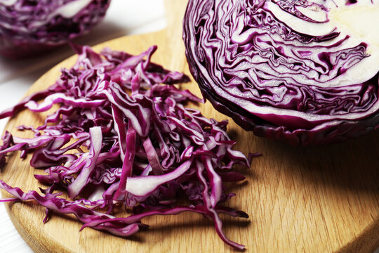 Cut fresh red cabbage on table, closeup