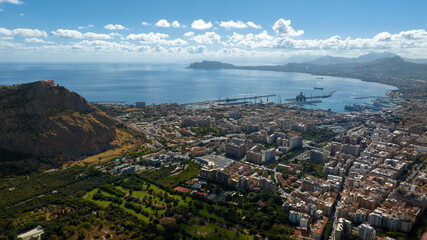 Panoramic aerial view of the Gulf of Palermo, Italy. The city, the capital of Sicily, overlooks the Mediterranean Sea with its houses and its important port.