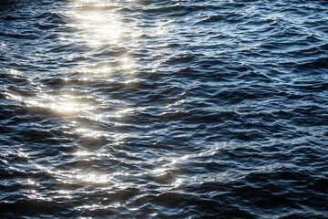 Glittering sea surface with reflections and waves.