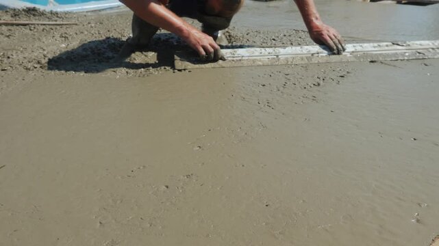 The builder levels the liquid concrete 4k video