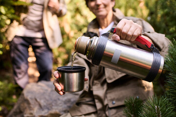 Fototapeta premium Active seniors share warm moments while hiking in the mountains together