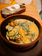 Delicious creamy dish with potatoes and herbs served at a cozy restaurant