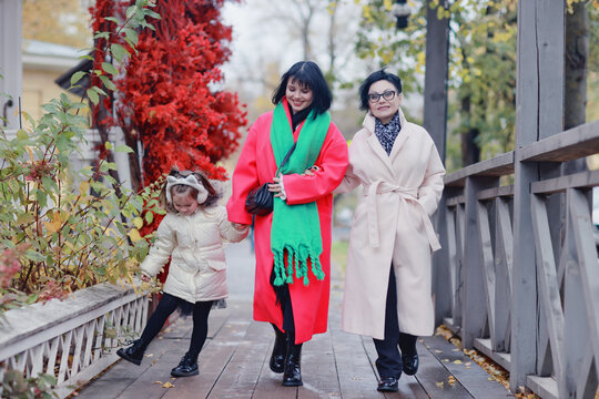Fototapeta family on a walk, women, daughter, mother, grandmother and granddaughter in the autumn city outside