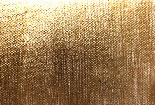 golden texture on canvas fabric closeup for background