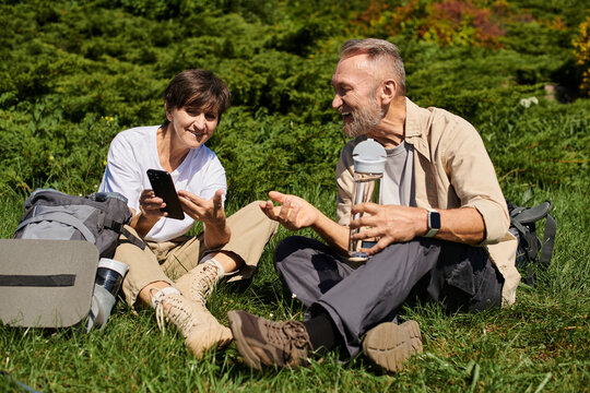 Senior couple enjoys a moment together while hiking - Powered by Adobe