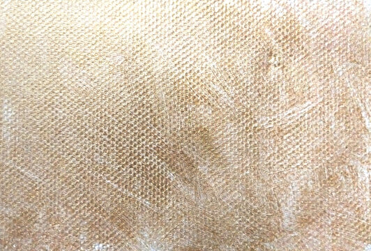 golden texture on canvas fabric closeup for background