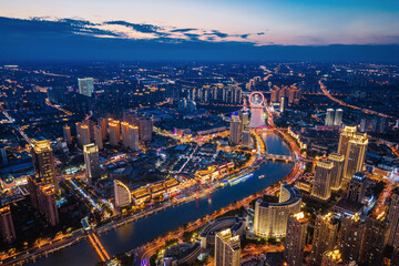 Fototapeta premium Aerial night view of Tianjin Eye Ferris wheel and city skyline in Tianjin, China