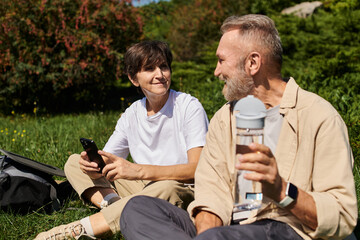 Fototapeta premium Active seniors exploring nature together, enjoying a mountain hike