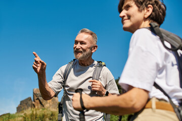 Senior couple enjoying an adventurous hike in nature on a sunny day