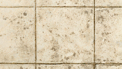 Aerial view of a floor with tiles worn over time. Ideal for textures, patterns and backgrounds.
