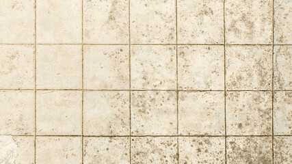 Aerial view of a floor with tiles worn over time. Ideal for textures, patterns and backgrounds.