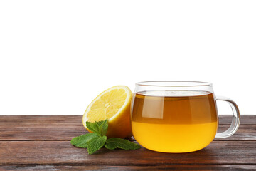 Aromatic tea in cup with lemon and mint on wooden table against white background, space for text