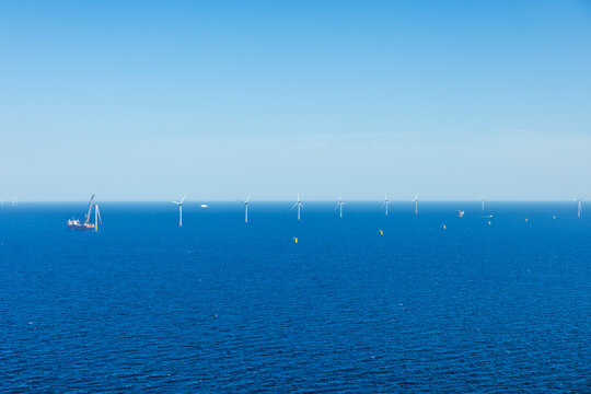 Installation vessel installing rotor blades in an offshore wind farm in the Baltic Sea.
