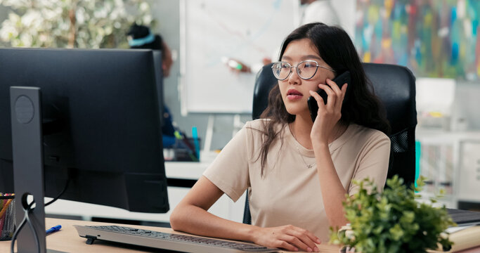 A young girl spends her morning in the office, sitting in front of a computer, speaking on the phone with a client, scheduling an appointment, and resolving a misunderstanding about paperwork.